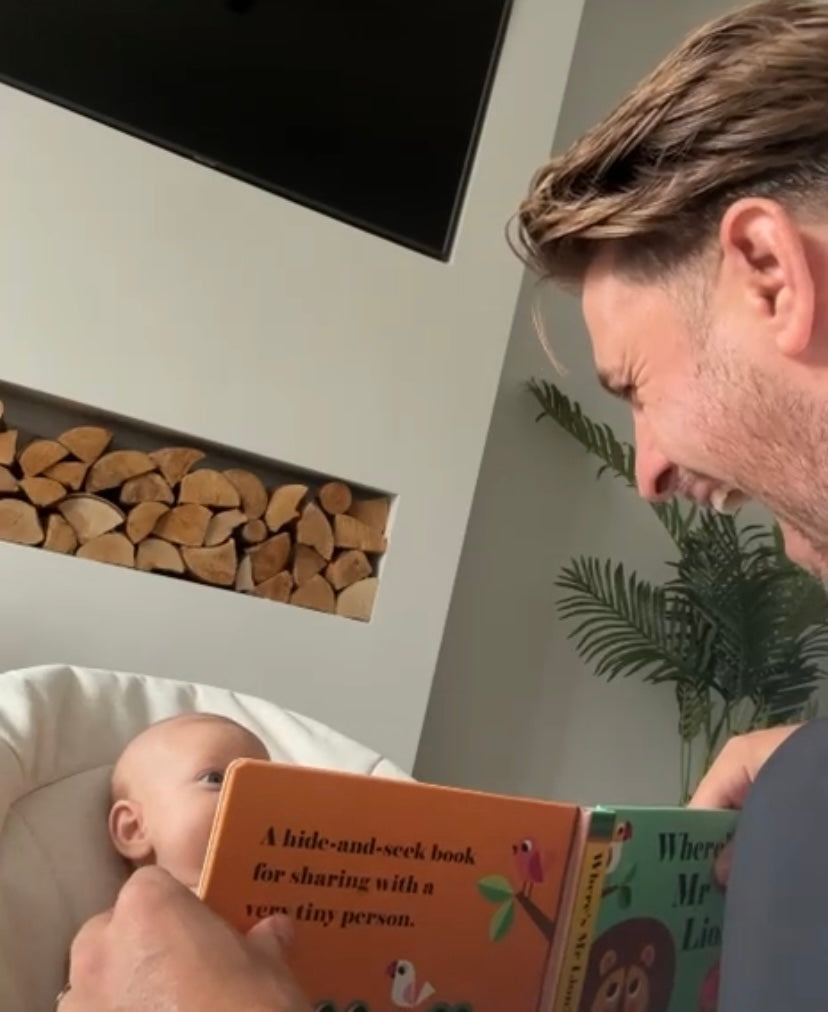 Dad reading book to baby 
